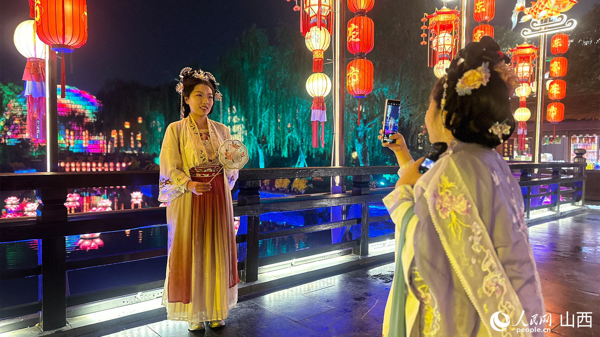 游客穿著宋制漢服在清明上河園景區打卡拍照。人民網記者 董童攝