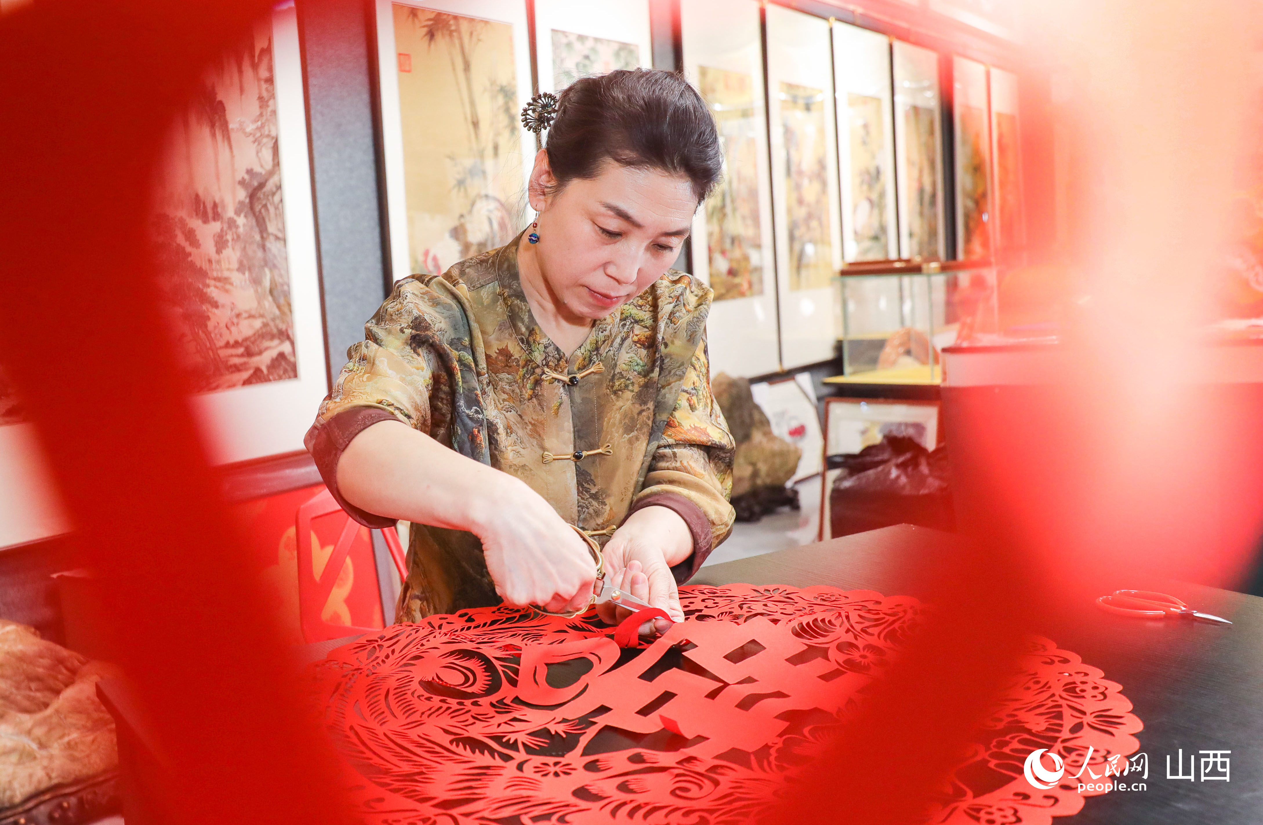 王銀鳳正在制作有喜慶寓意的剪紙作品。